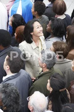 Chinese Woman Facing The Other Direction From The Multiethnic Crowd Stock Photos