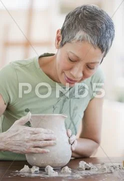 Chinese woman shaping clay pot Stock Photos