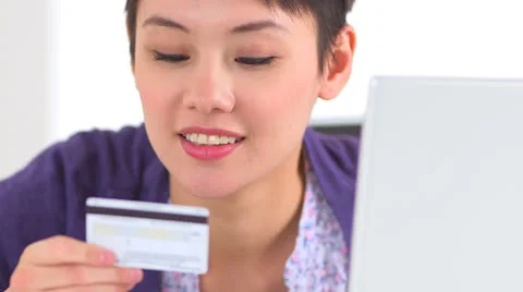 Chinese woman typing in credit card number Stock Footage