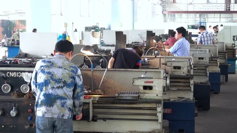 Chinese worker are working on machine tool  in factory 库存影片 75845956