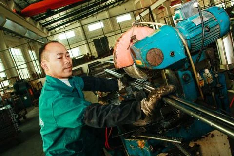 Chinese worker, man working on the machine Stock Photos