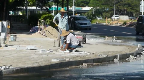 Chinese workers are in the road construction Stock Footage 65390626