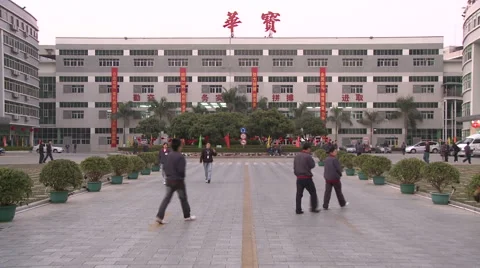 Chinese workers in China Donguan Shoe Factory - main building workers passing by Stock Footage