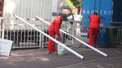 Chinese workers in the construction and installation of the sidewalk railing Stock Footage 65305692