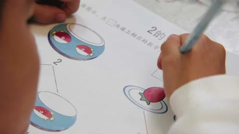 Chinese Young Boy Writing And Doing Homework At Dinner Table Video stock 171655152