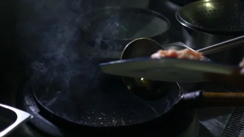 Chinesse food. Working chef preparing chinese food, Food frying in wok pan. Video stock 117743382