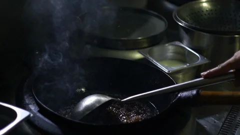 Chinesse food. Working chef preparing chinese food, Food frying in wok pan. Video stock 117743623
