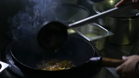 Chinesse food. Working chef preparing chinese food, Food frying in wok pan. Video stock 117743648