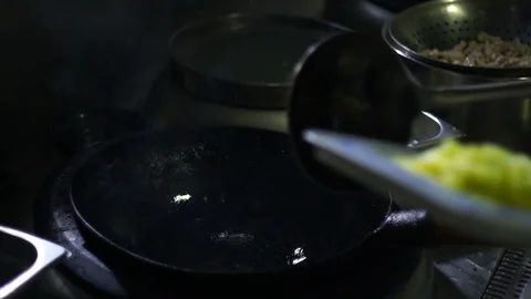 Chinesse food. Working chef preparing chinese food, Food frying in wok pan. Video stock 117782334