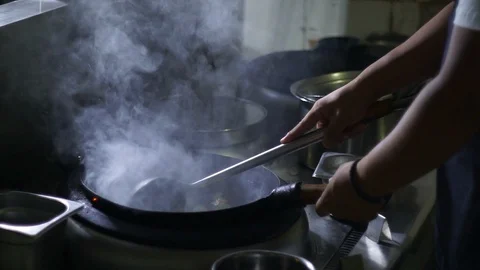 Chinesse food. Working chef preparing chinese food, Food frying in wok pan. Video stock 117784638