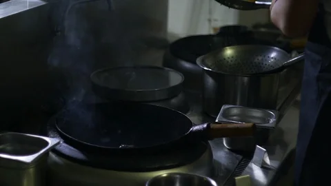 Chinesse food. Working chef preparing chinese food, Food frying in wok pan. Video stock 117784754