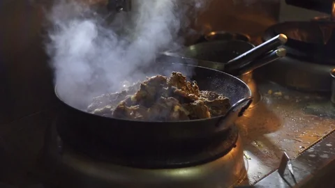 Chinesse food. Working chef preparing chinese food, Food frying in wok pan. Video stock 117807401