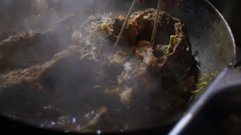 Chinesse food. Working chef preparing chinese food, Food frying in wok pan. Video stock 117807413