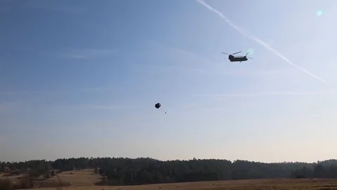Chinook helicopter parachuting a package 2 Stock Footage 110795308