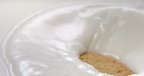 Chip cookie splashing into milk in super slow motion 1000 fps Stock Footage 344849314