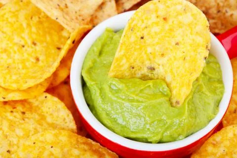 Chip in guacamole macro Stock Photos