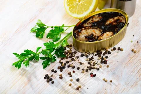 Chipirones in ink with parsley, lemon and spices Stock Photos