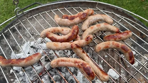 Chipolatas cooking on a BBQ Stock Footage 288011647
