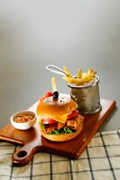 Chipotle chicken burger include cheese slice, tomato, onion and lettuce lea.. Stock Photos