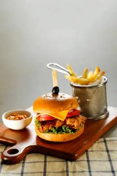 Chipotle chicken burger include cheese slice, tomato, onion and lettuce lea.. Stock Photos