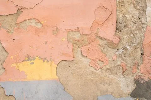 Chipped paint on an old plaster wall, cracked, texture background Stock Photos