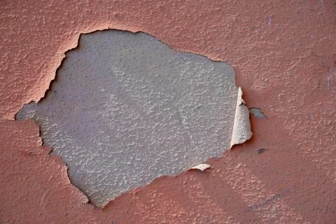 Chipped paint on rough stucco wall texture salmon Stock Photos