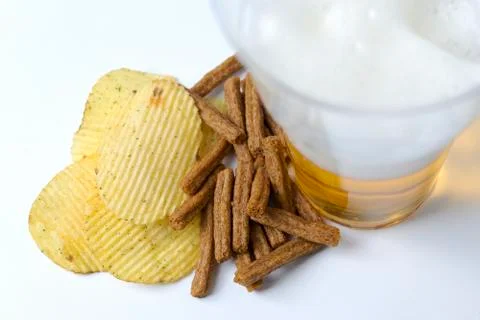 Chips and crackers on a white background with beer. Stock-Fotos