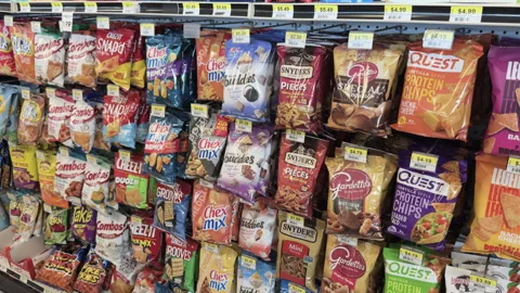 Chips and snacks hanging in gas station food section 4k Video stock 309258346