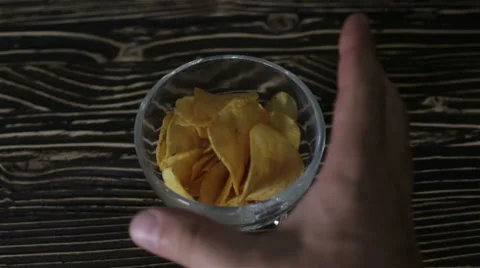 Chips are in a glass vase on the table Stock Footage 63052165