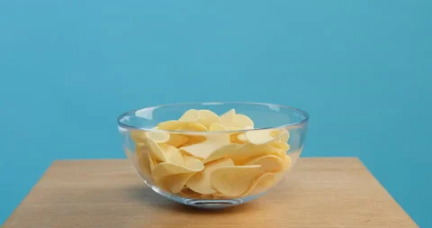 Chips are poured into a plate Stock Footage 154083750