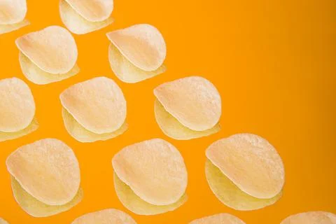 Chips background. Bunch of crisps snack on background with space Stock Photos