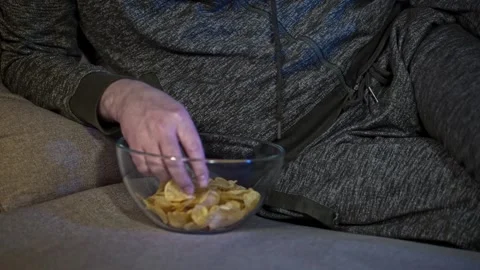 Chips, binge-watching, and relaxation. Stock Footage 300311524