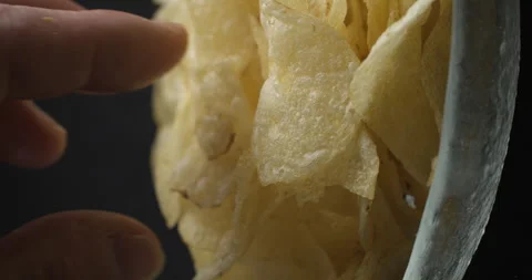 Chips close-up picking in studio 4K vertical view Stockbeeldmateriaal 277002636