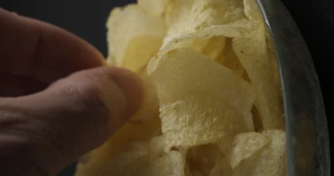 Chips close-up picking in studio 4K vertical view Stock-Footage 277003054