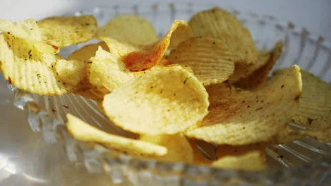 Chips falling in black bowl Stock Footage 139810756