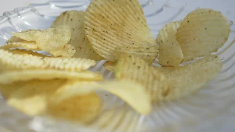 Chips falling in black bowl Stock Footage 139810907