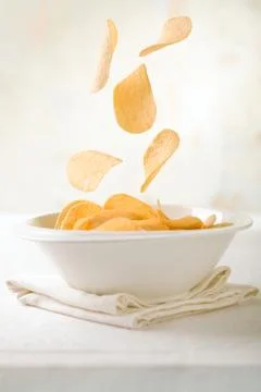 Chips Falling in a Bowl Stock Photos