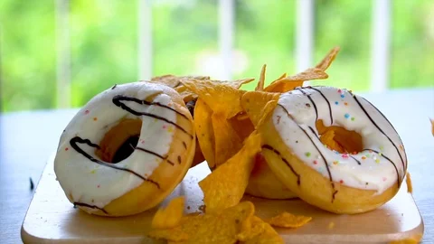 Chips Falling Down on Unhealthy Donuts Stock Footage 105838801