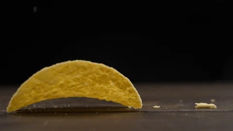 Chips falling onto a wooden surface Stock Footage 111379673