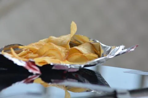 Chips on foil reflective surface clean composition Stock Photos