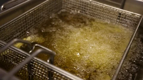 Chips in fryer being deep fried, slow motion Stock Footage 274808671