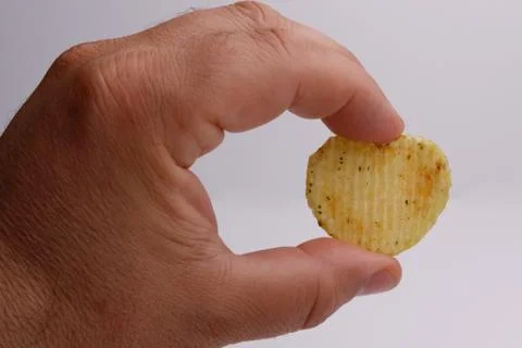 Chips heart in hand on white background 库存照片