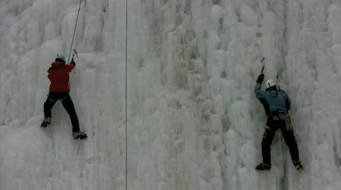 Chips of ice fall from ice climbers Stock Footage 313665