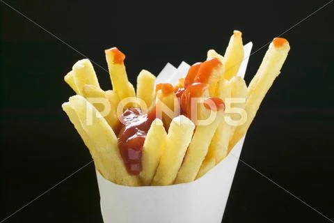 Chips with ketchup in paper cone Stock Photos