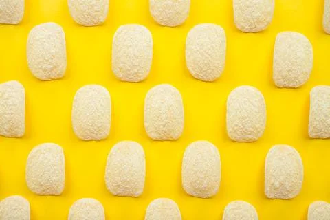 Chips pattern on a bright yellow background. Weight loss and diet concept. Stock Photos