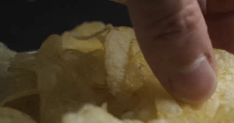 Chips picking close-up in studio 4K Stockbeeldmateriaal 277002238
