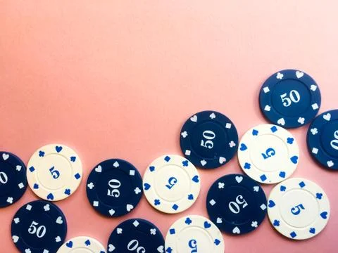 Chips for poker on pink background. Five and fifty chips. Copy space. Gamblin Stock Photos