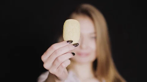 Chips from potatoes. The girl eats potato chips. A woman holds chips in her Vídeo Stock 88913804