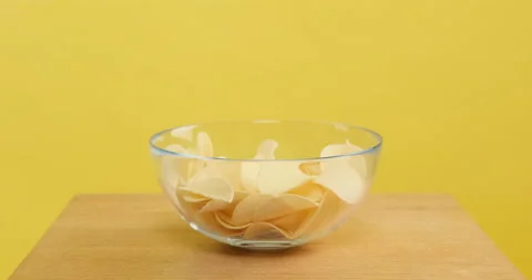 Chips pouring into a plate Video stock 154083391