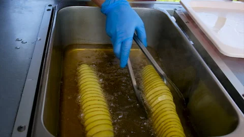 Chips spiral deep-fried in the kitchen. Selective focus. Stock Footage 195094595